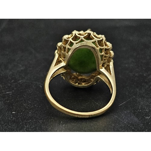 291 - A Fine polished cabbage leaf Jade ring set in 14K gold. 
Size P. 5.83g total weight.