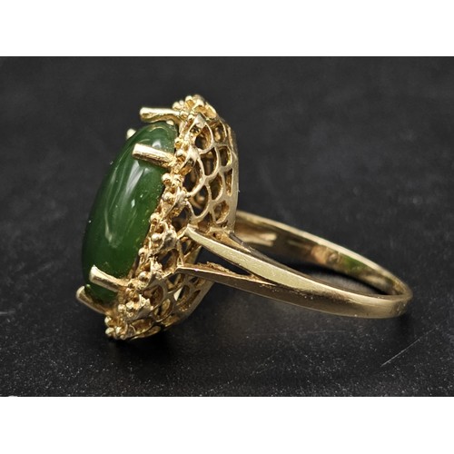 291 - A Fine polished cabbage leaf Jade ring set in 14K gold. 
Size P. 5.83g total weight.