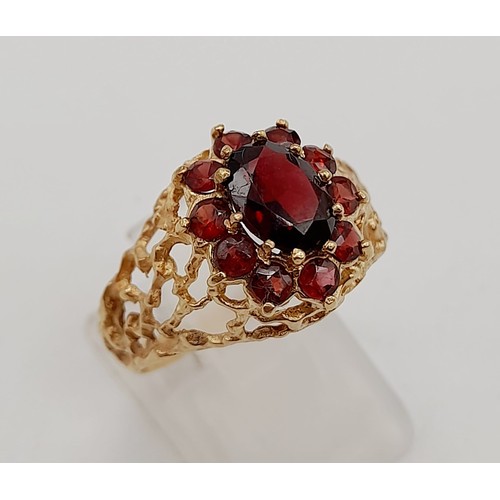 1438 - 1960’s oval cluster garnet ring surrounded by a halo of bright red garnets in a stylish bark design.... 