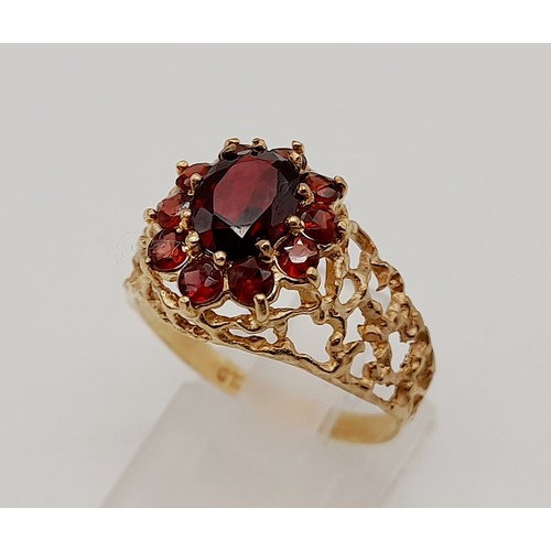 1438 - 1960’s oval cluster garnet ring surrounded by a halo of bright red garnets in a stylish bark design.... 