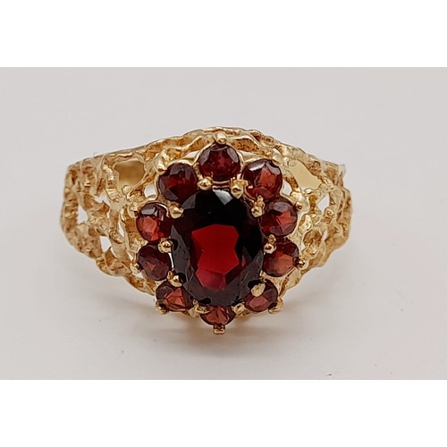 1438 - 1960’s oval cluster garnet ring surrounded by a halo of bright red garnets in a stylish bark design.... 