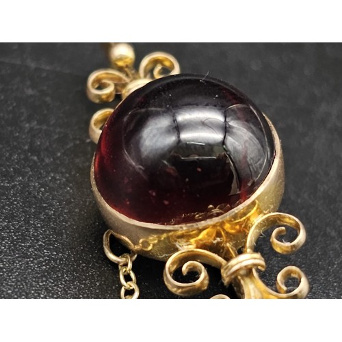 362 - Large Victorian cabochon garnet carbuncle in a fancy decorated brooch. Set in 9K gold. 4.5cm. 6g tot... 