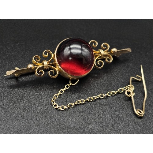 362 - Large Victorian cabochon garnet carbuncle in a fancy decorated brooch. Set in 9K gold. 4.5cm. 6g tot... 