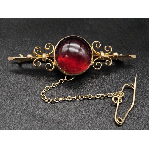 362 - Large Victorian cabochon garnet carbuncle in a fancy decorated brooch. Set in 9K gold. 4.5cm. 6g tot... 