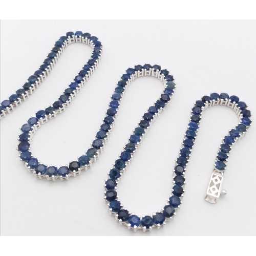 153 - A 925 Silver and Blue Sapphire Tennis Necklace. Total Weight 32grams. 44cm in Length.