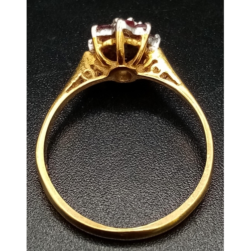 55 - An 18K Yellow Gold Ruby and Diamond Ring. Central small diamond with a ruby gemstone halo. Size M 1/... 