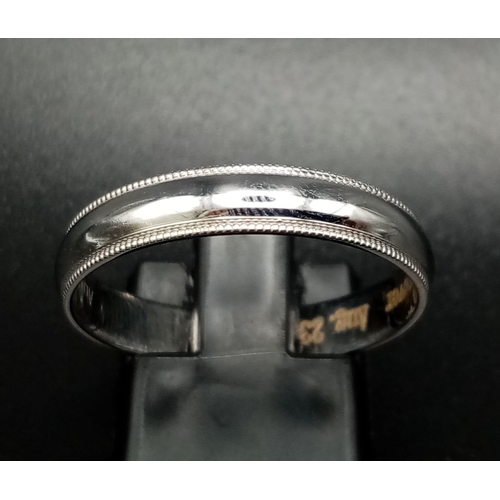 71 - An 18K White Gold Band Ring. Inscription on inner. Size T. 3.57g