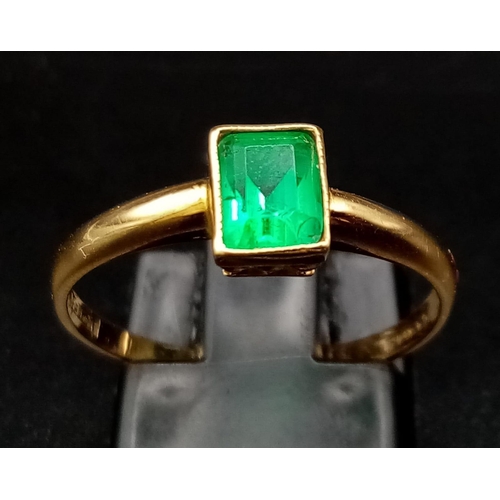 76 - An 18K Yellow Gold Emerald Solitaire Ring. Size O. 2.08g total weight.