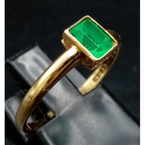 76 - An 18K Yellow Gold Emerald Solitaire Ring. Size O. 2.08g total weight.