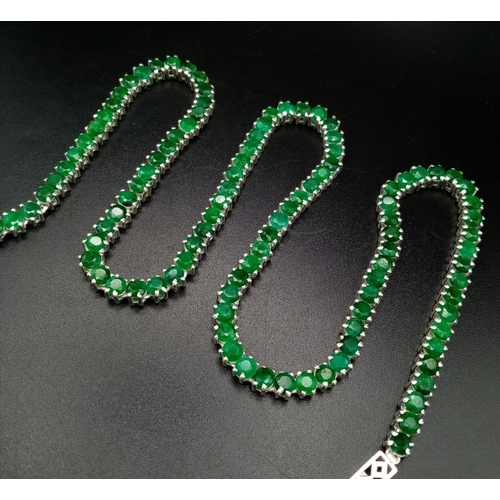 88 - A 925 Silver and Emerald Tennis Necklace. Total Weight 32grams. 46cm in length.