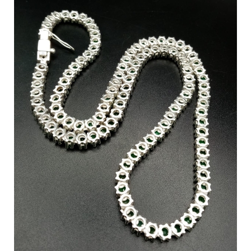 88 - A 925 Silver and Emerald Tennis Necklace. Total Weight 32grams. 46cm in length.