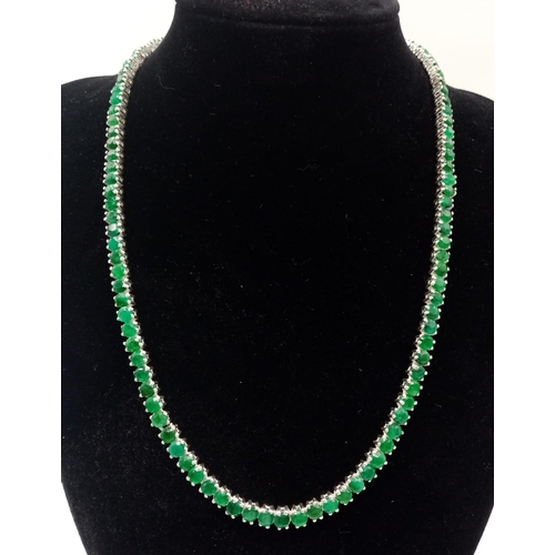 88 - A 925 Silver and Emerald Tennis Necklace. Total Weight 32grams. 46cm in length.