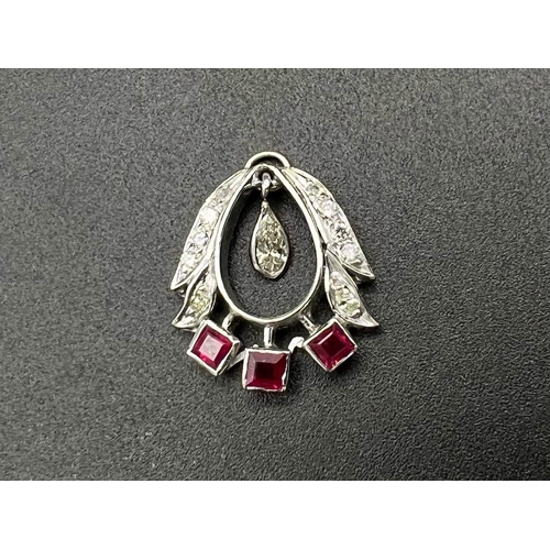 155 - A 9K White Gold Ruby and Diamond Pendant. 2cm. 2.9g total weight.