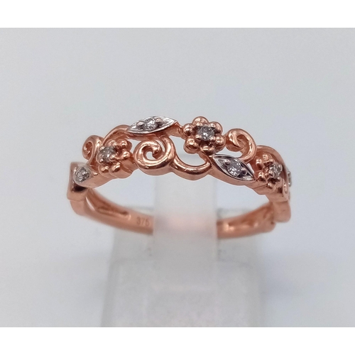 765 - 9K ROSE GOLD DIAMOND SET FANCY BAND RING FLORAL DESIGN. TOTAL WEIGHT  2G. SIZE M