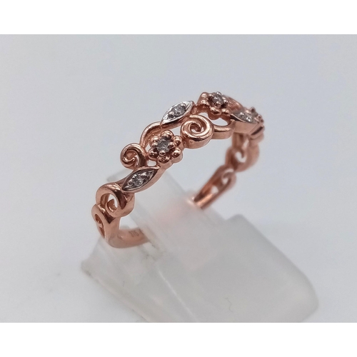 765 - 9K ROSE GOLD DIAMOND SET FANCY BAND RING FLORAL DESIGN. TOTAL WEIGHT  2G. SIZE M