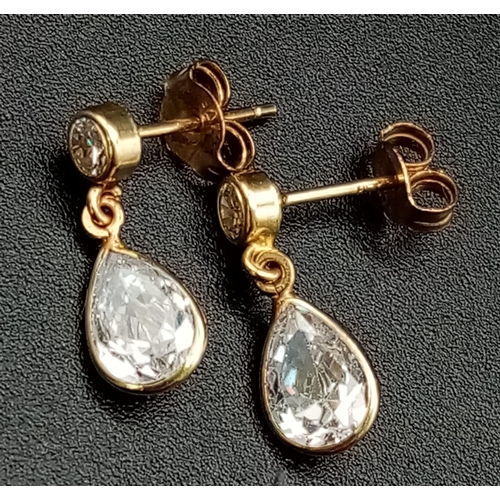 1299 - A Pair of 9K Yellow Gold CZ Earrings. Bright white pear shape drops.