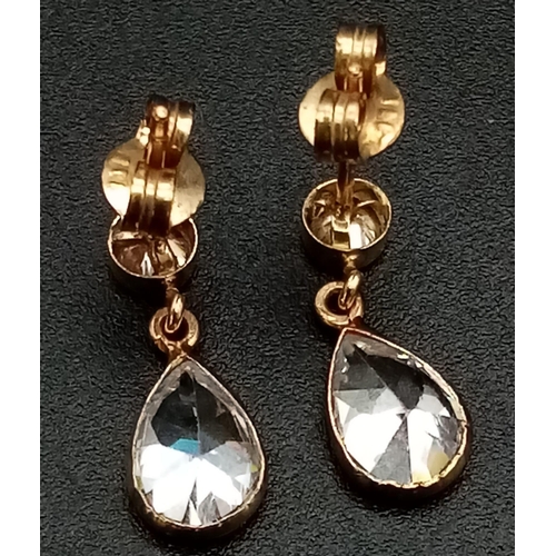 1299 - A Pair of 9K Yellow Gold CZ Earrings. Bright white pear shape drops.