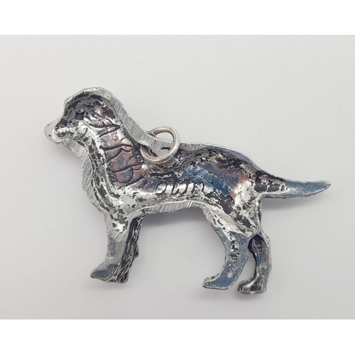 1099 - A sterling silver pendant in the shape of a dog. Length: 42 mm, weight: 7.4 g.