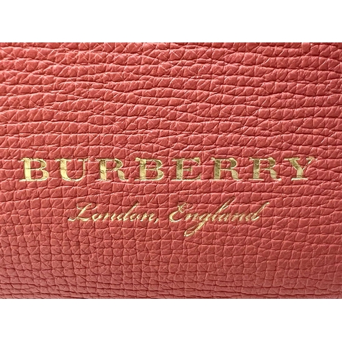 8 - A Burberry Red Leather Handbag. Two tone exterior with teddy bear mascot. Gold-tone hardware. Black ... 