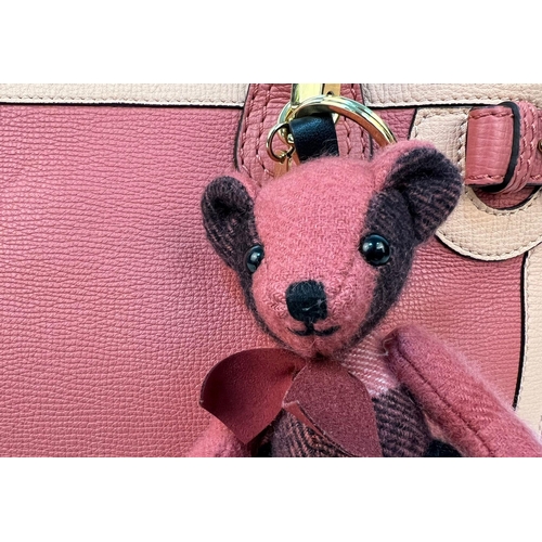 8 - A Burberry Red Leather Handbag. Two tone exterior with teddy bear mascot. Gold-tone hardware. Black ... 