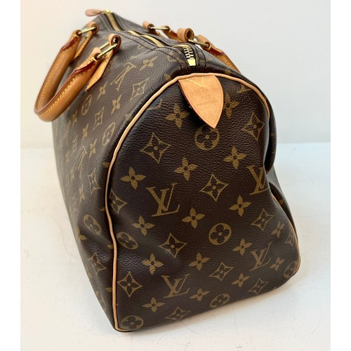 A Louis Vuitton Monogram Ladies Speedy Bag. Brown LV canvas with brown  leather handles and gold-tone