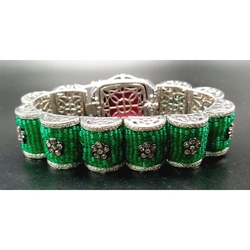 74 - A REAL STATEMENT PIECE OF JEWELLERY, A SENSATIONAL 18K WHITE GOLD BRACELET COVERED IN EMERALDS AND D... 