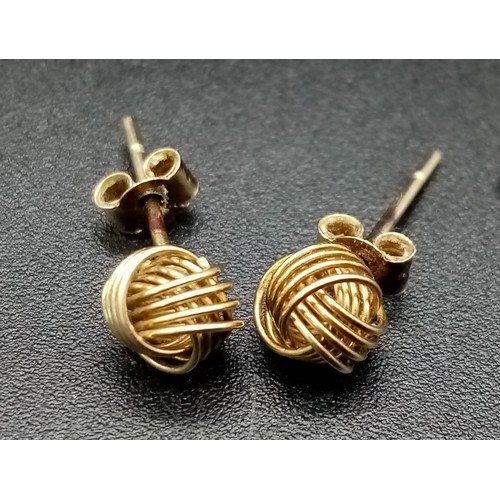 1108 - A pair of knot design 9k gold earrings. 0.6g total weight.