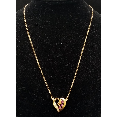 72 - An 18 k yellow gold chain necklace with a heart pendant adorned with rubies and diamonds. Length: 43... 