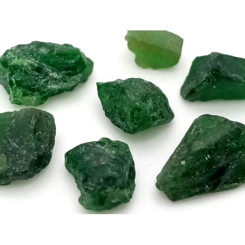 1092 - A 11.15ctw Lot of Rough Green Diopside Gemstones. GLA Certified.