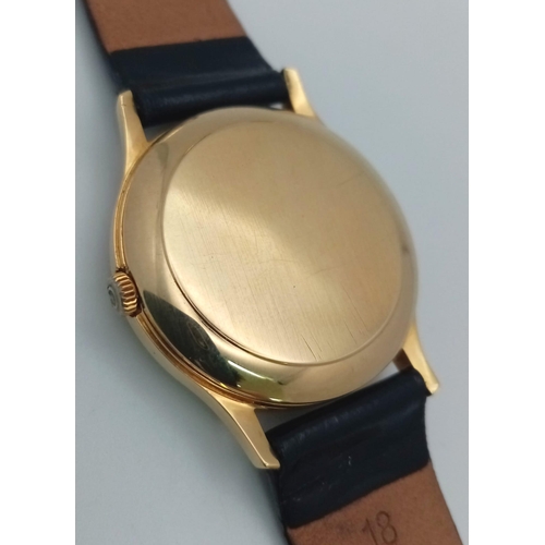 113 - A Vintage 18K Gold Omega Deville Automatic Gents Watch. Black leather strap. 18K gold case - 33mm. S... 