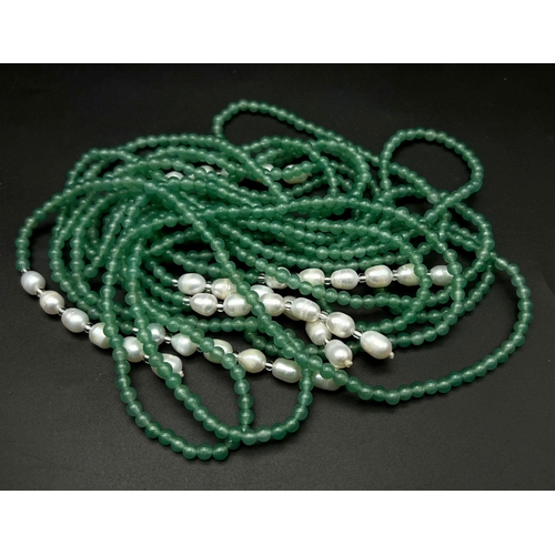 147 - A very feminine, Belle Epoque reminiscent necklace. Three long strands (130 cm) of pale green jade a... 