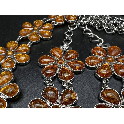 238 - A substantial, floral design, amber necklace and bracelet set in a presentation box. Necklace length... 