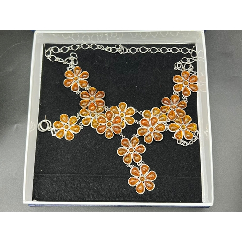 238 - A substantial, floral design, amber necklace and bracelet set in a presentation box. Necklace length... 