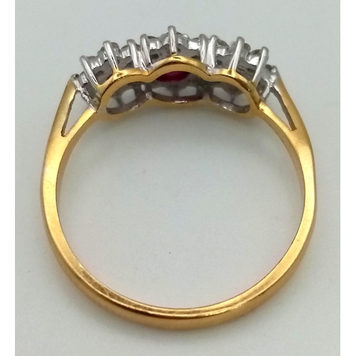 303 - An 18K Yellow Gold Ruby and Diamond Ring. Three rubies all with a halo of diamonds. UK Hallmarks. Si... 