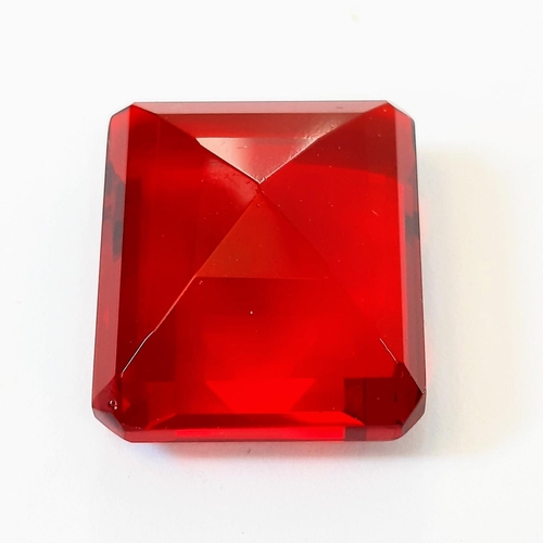 336 - A beautiful, but unidentified, large (58 carats) red stone. Emerald cut, with no inclusions, scratch... 