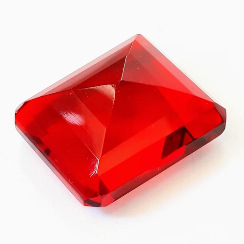 336 - A beautiful, but unidentified, large (58 carats) red stone. Emerald cut, with no inclusions, scratch... 