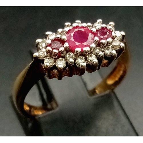 408 - A 9K Yellow Gold Ruby and Diamond Ring - Three rubies with a diamond surround. Size L. 2.5g total we... 