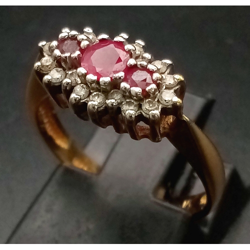 408 - A 9K Yellow Gold Ruby and Diamond Ring - Three rubies with a diamond surround. Size L. 2.5g total we... 