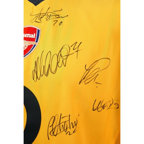 49 - An Arsenal Football Club Signed 2006 Away O2 Yellow Shirt. Fifteen signatures including: Van Persie,... 