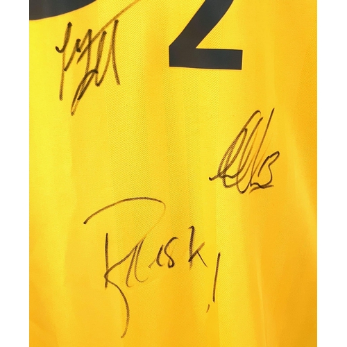 49 - An Arsenal Football Club Signed 2006 Away O2 Yellow Shirt. Fifteen signatures including: Van Persie,... 