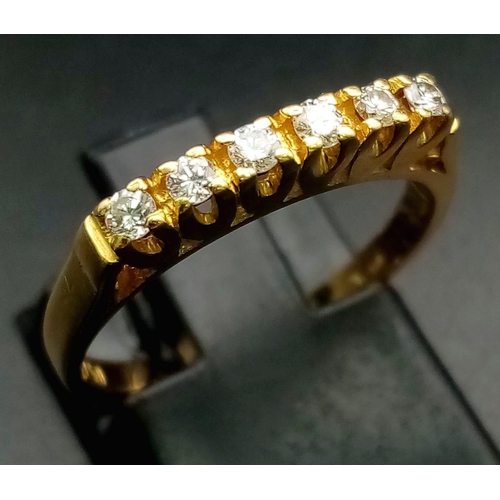 579 - An 18K Yellow Gold Half-Eternity Diamond Ring. Six diamonds - 0.30ctw. Size L. 2.6g total weight.