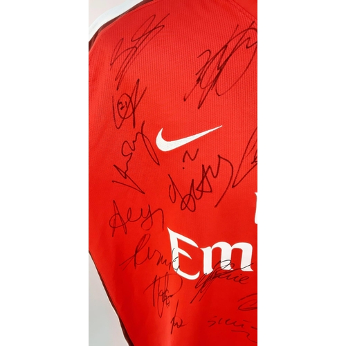 90 - An Arsenal Football Club 2008 Signed Home Emirates Red Shirt - Still with shop tags. 24 signatures. ... 