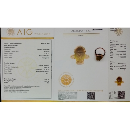 91 - A 14K Rose Gold 9.6ct Tourmaline Ring in the Carved Shape of a Buddha. Size L. Comes with an AIG Mil... 