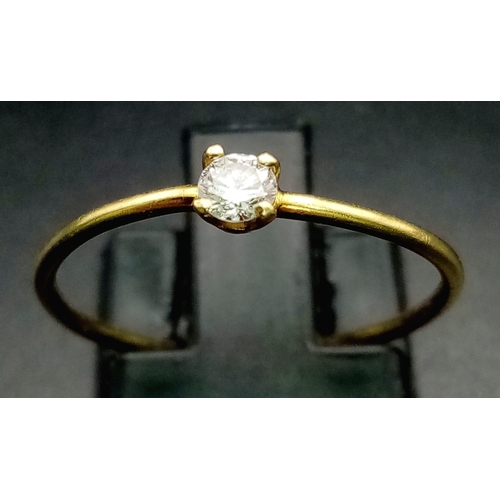 953 - An 18K Yellow Gold Diamond Solitaire Ring. 0.10ct. Size M.
0.85g total weight.