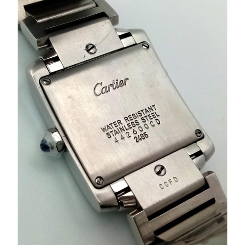 390 - A Cartier Tank Ladies Watch. Stainless steel bracelet and case - 25 x 28mm. White dial with Roman nu... 