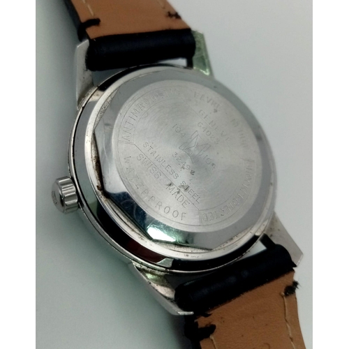 428 - A 1970s Favre-Leuba Datic Gents Watch. Black leather strap.
Stainless steel case - 35mm. White dial ... 