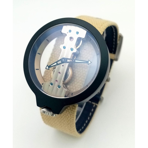 568 - A Verticale Mechanical Gents Watch. Beige cloth strap. Black case - 42mm. Skeleton dial. In excellen... 