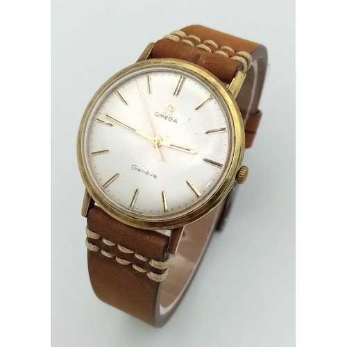 943 - A Vintage Omega Geneve Gents Watch. Brown leather strap. Two-tone case - 34mm. Silver-tone dial. Mec... 