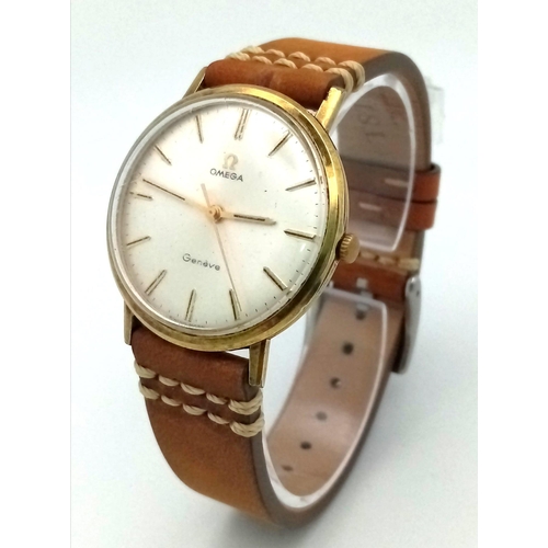 943 - A Vintage Omega Geneve Gents Watch. Brown leather strap. Two-tone case - 34mm. Silver-tone dial. Mec... 