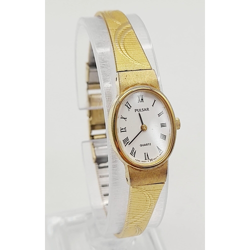 1155 - A ladies, gold plated PULSAR WATCH. Oval case 19 x 15 mm, white dial with Roman numerals, Japanese q... 